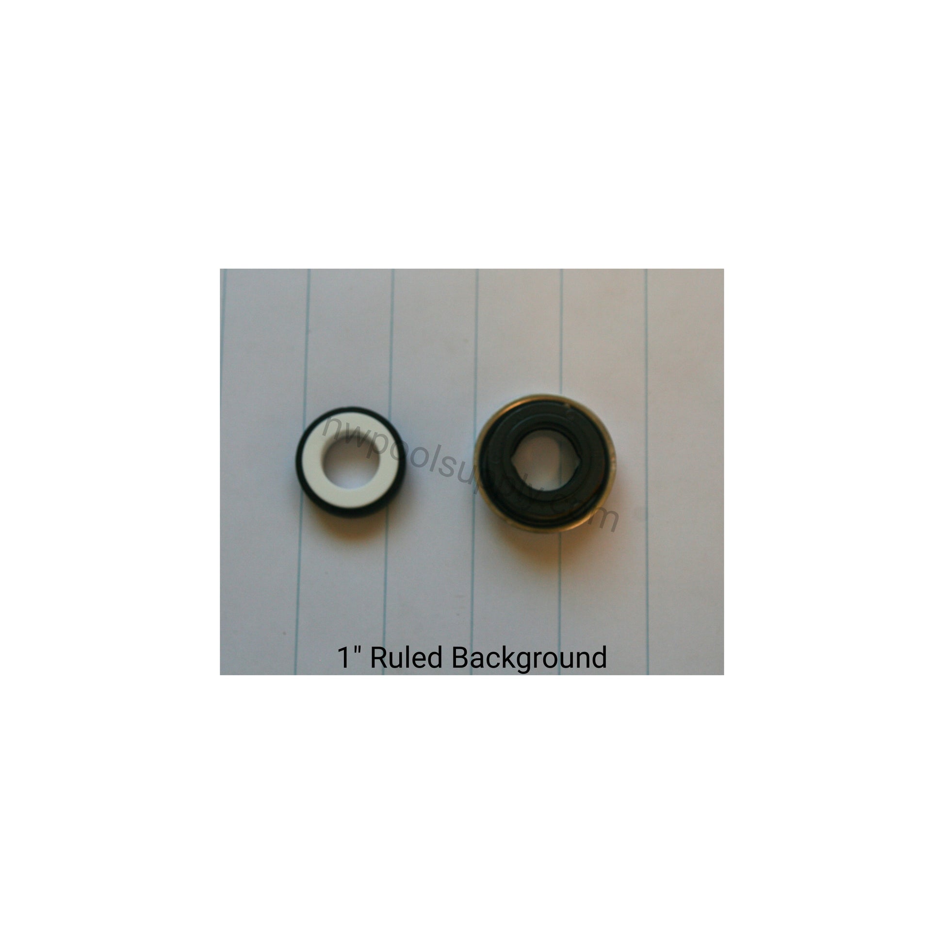 Two black and white circular objects on a piece of paper with ruled lines. U.S Seal PS1000 General Service Seal Assembly